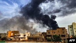 Smoke plumes billow from a fire at a lumber warehouse in southern Khartoum amidst ongoing fighting on June 7, 2023. 