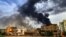 Smoke plumes billow from a fire at a lumber warehouse in southern Khartoum amidst ongoing fighting on June 7, 2023. 