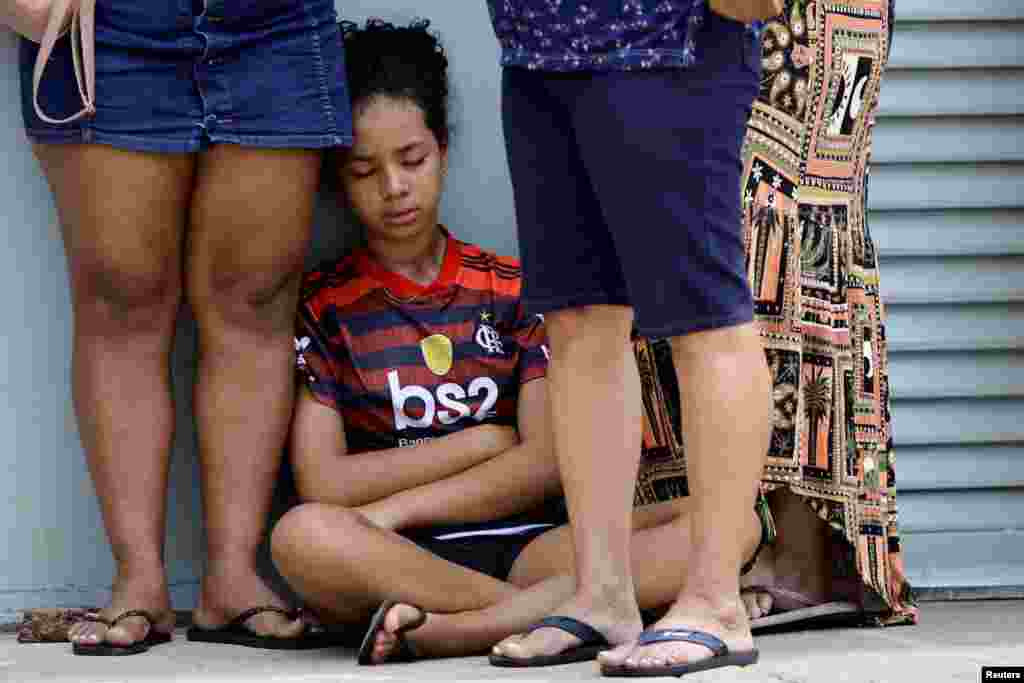 Patients wait in line to receive medical attention in a makeshift tent to treat suspected dengue cases, in the administrative region of Ceilandia, on the outskirts of Brasilia, Brazil, Feb. 5, 2024. 