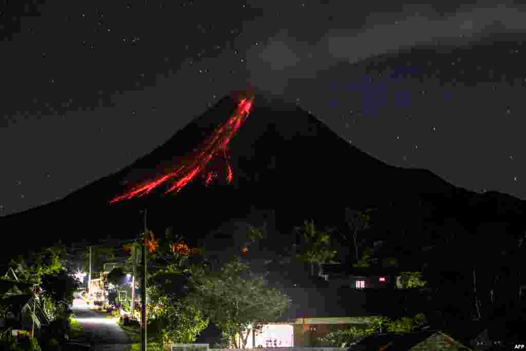 Volcano Merapi spews lava during an eruption seen from Wonokerto village in Sleman, Indonesia.