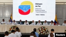 FILE - Representatives of Colombia's government and the Segunda Marquetalia armed group are seen during a press conference after the start of peace talks, in Caracas, Venezuela, June 24, 2024. 