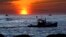Lobster fishermen work at sunrise, Sept. 8, 2022, off Kennebunkport, Maine. The waters off New England logged the second-warmest year in their recorded history in 2022, according to researchers. 
