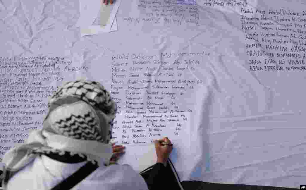 Pro-Palestinian supporters write names of lives lost during the war, as they protest outside Parliament in Cape Town, South Africa.&nbsp;The majority of MPs voted to close the Israeli embassy in South Africa over the war in Gaza.&nbsp;