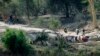 FILE — Zimbabweans wait to cross into South Africa on the dry bed of the Limpopo river, east of the border town of Musina, South Africa, June 30, 2020.