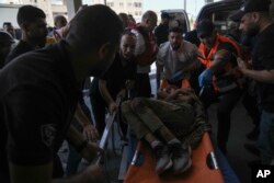 An injured Palestinian is carried into a hospital during an Israeli military raid in the Jenin refugee camp, a militant stronghold in the occupied West Bank, July 3, 2023.