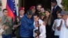 Venezuelan President Maduro, center left, embraces Alex Saab after Saab arrived at Miraflores presidential palace in Caracas, Venezuela, Dec. 20, 2023.