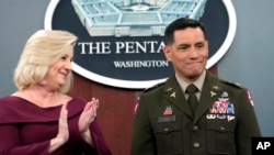 Army Secretary Christine Wormuth applauds after giving the Army Astronaut Device to Col. Frank Rubio at a ceremony at the Pentagon in Washington, Feb. 22, 2024. Rubio holds the U.S. record for the most days in space for a single spaceflight - 371.