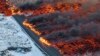 Foto udara menunjukkan aliran lava melintasi jalan utama menuju Grindavík dan mengalir di jalan menuju Blue Lagoon, di Grindavík, Islandia pasca letusan gunung berapi di barat daya Islandia. (AP)&nbsp;