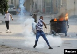 FILE — Palestinians clash with Israeli troops after a settlers' attack in Deir Sharaf, near Nablus in the Israeli-occupied West Bank, Nov. 2, 2023.