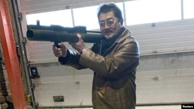 FILE - Takeshi Ebisawa is pictured with a rocket launcher during a meeting with an informant and two undercover Danish police officers at a warehouse in Copenhagen, Feb. 3, 2021, in a photo from a Drug Enforcement Administration criminal complaint.