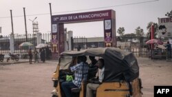 A "tuk-tuk" cab passes the entrance to one of the facilities of the 9th Jeux de la Francophonie in Kinshasa, Democratic Republic of Congo, on July 25, 2023. 