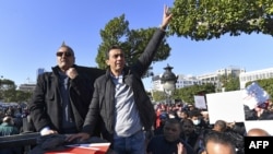FILE - Jawhar Ben Mbarek, a member of the "Citizens Against Coup" campaign, gestures during a demonstration against President Kais Saied on December 17, 2021 in the capital Tunis, on the 11th anniversary of the start of the 2011 revolution.