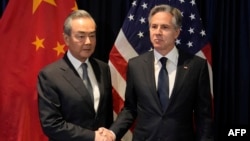 FILE - U.S. Secretary of State Blinken shakes hands with Director of the Office of the Foreign Affairs Commission of the Communist Party of China's Central Committee Wang Yi during their meeting in Jakarta, July 13, 2023. 