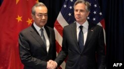 US Secretary of State Blinken shakes hands with Director of the Office of the Foreign Affairs Commission of the Communist Party of China's Central Committee Wang Yi during their meeting in Jakarta, July 13, 2023. (Photo by Dita Alangkara / Pool / AFP)