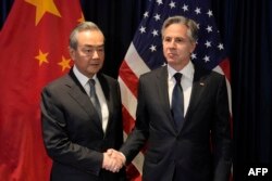 US Secretary of State Blinken shakes hands with Director of the Office of the Foreign Affairs Commission of the Communist Party of China's Central Committee Wang Yi during their meeting in Jakarta, July 13, 2023. (Photo by Dita Alangkara / Pool / AFP)