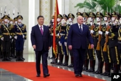 FILE - Visiting Belarusian President Alexander Lukashenko and Chinese President Xi Jinping review an honor guard during a welcome ceremony at the Great Hall of the People in Beijing, March 1, 2023. (Xinhua via AP)
