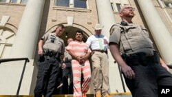 FILE - Francisco Oropeza, center, is escorted from the San Jacinto County courthouse by San Jacinto County Sheriff Greg Capers, second from right, May 18, 2023, in Coldspring, Texas.