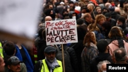 Protesters attend a demonstration as part of the ninth day of nationwide strikes and protests against French government's pension reform, in Paris, March 23, 2023.
