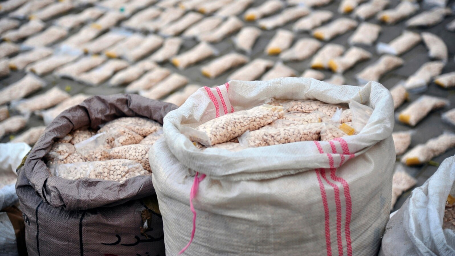 FILE - In this photo released by the Syrian official news agency SANA, Syrian authorities display Captagon pills in rural Damascus, Syria, Nov. 30, 2021. 