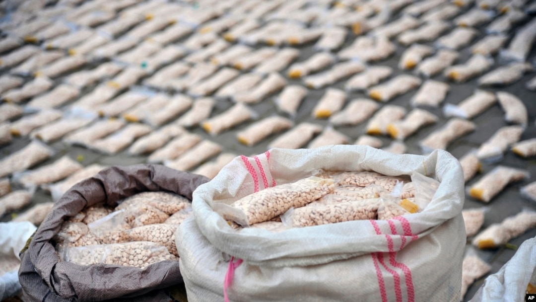 FILE - In this photo released by the Syrian official news agency SANA, Syrian authorities display Captagon pills, in rural Damascus, Syria, Nov. 30, 2021. 