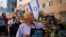 Members of the African Hebrew Israelites of Jerusalem rally outside of the District Court in Beersheba, Israel, ahead of a hearing on the deportation orders for dozens from their community, July 19, 2023.