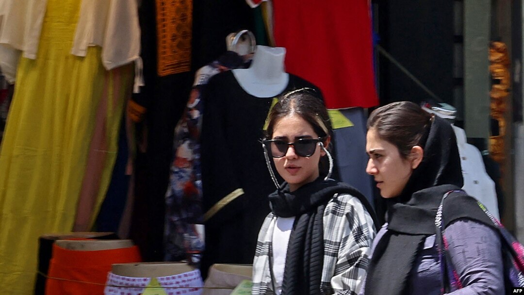 Women shop in Tehran on July 18, 2023, as the police relaunched patrols to catch women leaving their hair uncovered in public. Actress Afsaneh Bayegan received a suspended two-year prison sentence on July 19, 2023, for not wearing the compulsory hijab.