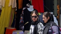 Women shop in Tehran on July 18, 2023, as the police relaunched patrols to catch women leaving their hair uncovered in public. Actress Afsaneh Bayegan received a suspended two-year prison sentence on July 19, 2023, for not wearing the compulsory hijab.