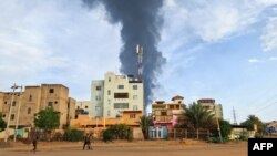 Smoke billows behind buildings amid ongoing fighting in Khartoum on June 9, 2023. 