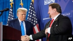 FILE - Nevada Republican chair Michael McDonald, right, greets Republican presidential candidate Donald Trump in Las Vegas, Jan. 27, 2024. A Nevada state court judge dismissed a criminal indictment Friday against so-called fake electors in Nevada's 2020 election.  