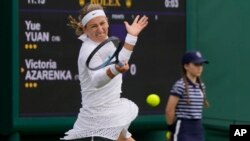 Victoria Azarenka of Belarus plays a return to China's Yuan Yue during the first round women's singles match on day one of the Wimbledon tennis championships near London, July 3, 2023.