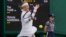Victoria Azarenka of Belarus plays a return to China's Yuan Yue during the first round women's singles match on day one of the Wimbledon tennis championships near London, July 3, 2023.