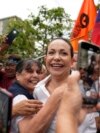 Supporters embrace opposition leader Maria Corina Machado during a rally in San Antonio, Venezuela, April 17, 2024. The Biden administration on Wednesday reimposed oil sanctions on Venezuela, admonishing Nicolas Maduro's efforts to consolidate his rule.