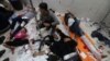
Wounded Palestinians are assisted at Nasser hospital, following Israeli strikes on Ma'an school east of Khan Younis, in Khan Younis in the southern Gaza Strip, Dec. 5, 2023.