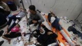 FILE - Wounded Palestinians are assisted at Nasser hospital, following Israeli strikes on Ma'an school east of Khan Younis, in Khan Younis in the southern Gaza Strip, Dec. 5, 2023.