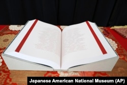 FILE - The Ireichō, lists the names of the more than 125,000 people who were detained in internment camps for Japanese Americans nationwide during World War II, at the museum in Los Angeles, Sept. 24, 2022.