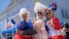 A trio of New Orleans women dressed as Marie-Antoinette enjoy this year's Fête Française, a New Orleans street festival celebrating French culture, on March 25, 2023. 