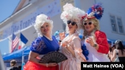 A trio of New Orleans women dressed as Marie-Antoinette enjoy this year's Fête Française, a New Orleans street festival celebrating French culture, on March 25, 2023. 