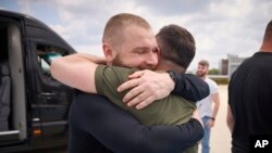 Photo by Ukrainian Presidential Press Office, Ukrainian President Volodymyr Zelenskyy, right, hugs defender of Azovstal plant Serhii Volynskyi in Istanbul, Turkey, July 8, 2023.