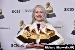 Phoebe Bridgers poses in the press room with awards during the 66th annual Grammy Awards on Sunday, Feb. 4, 2024, in Los Angeles. (Photo by Richard Shotwell/Invision/AP)
