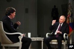 FILE - In this photo released by Sputnik news agency, Feb. 9, 2024, Russian President Vladimir Putin, right, speaks during an interview with former Fox News host Tucker Carlson at the Kremlin in Moscow, Russia, Feb. 6, 2024.