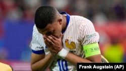 Kylian Mbappe of France reacts after an injury during a quarter final match between Portugal and France at the Euro 2024 soccer tournament in Hamburg, Germany, July 5, 2024.