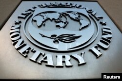 FILE - The International Monetary Fund logo is seen outside the headquarters building in Washington, Sept. 4, 2018. The IMF said on July 28, 2023, “Argentina's economic situation has become very challenging due to the larger-than-anticipated impact of a drought."
