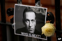 FILE - A tribute to Russian politician Alexey Navalny is posted near the Russian Embassy in London, Feb. 18, 2024. Navalny, 47, Russia's most well-known opposition politician, died unexpectedly on Feb. 16 in an Arctic penal colony.