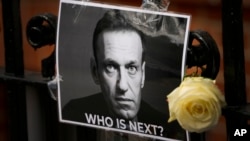 FILE - A tribute to Russian politician Alexey Navalny is posted near the Russian Embassy in London, Feb. 18, 2024. Navalny, 47, Russia's most well-known opposition politician, died unexpectedly last Friday in an Arctic penal colony.