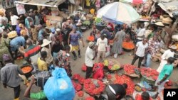 Pedestrians shop for pepper and other food items at the Mile 12 Market in Lagos, Nigeria, Feb. 16, 2024. Nigerians are facing one of the West African nation's worst economic crises in many years.