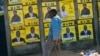 A boy leans near to campaign posters with images of candidates in Harare, Zimbabwe, on July 16, 2023.