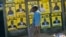 A boy leans near to campaign posters with images of candidates in Harare, Zimbabwe, on July 16, 2023.