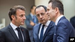 France's President Emmanuel Macron, left, speaks with Cypriot President Nikos Christodoulides, second right, and Slovakia's Prime Minister Ludovit Odor during a round table meeting at an EU summit in Brussels, June 29, 2023.