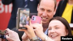 FILE - Prince William, Prince of Wales poses for a selfie during a visit to The Rectory in Birmingham, Britain, April 20, 2023.