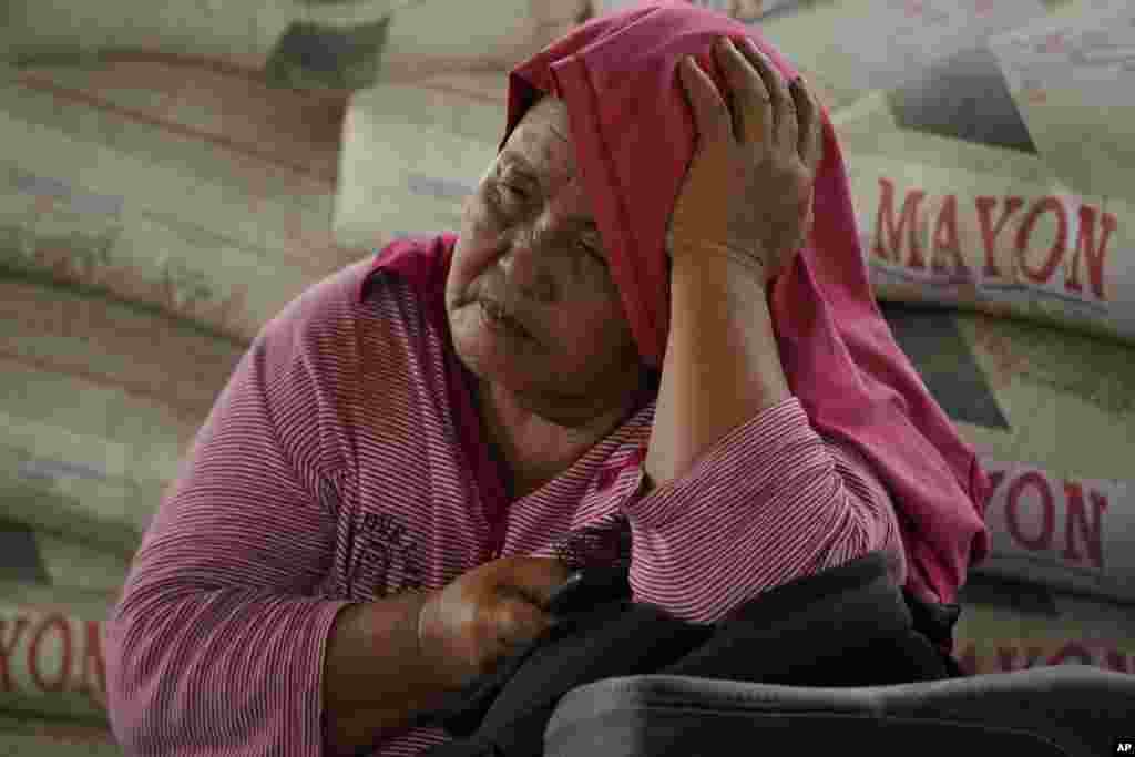 An evacuee rests at an evacuation center in Guinabotan, Albay province, northeastern Philippines.&nbsp;The Philippines&#39; most active volcano was gently spewing lava down its slopes, alerting tens of thousands of people they may have to quickly flee a violent and life-threatening explosion.